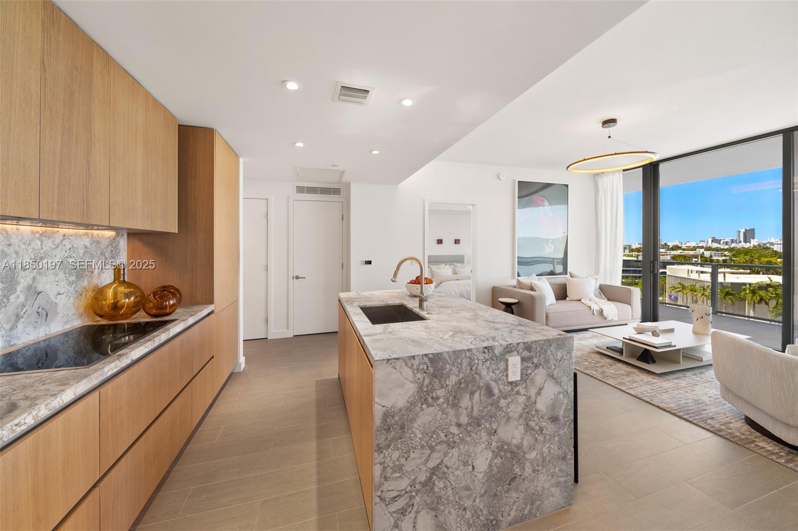 500 Alton Road, Unit 807 Miami Beach, FL 33139 - Photo 6 of 20 a kitchen filled counter top space a stove a sink cabinets and a window