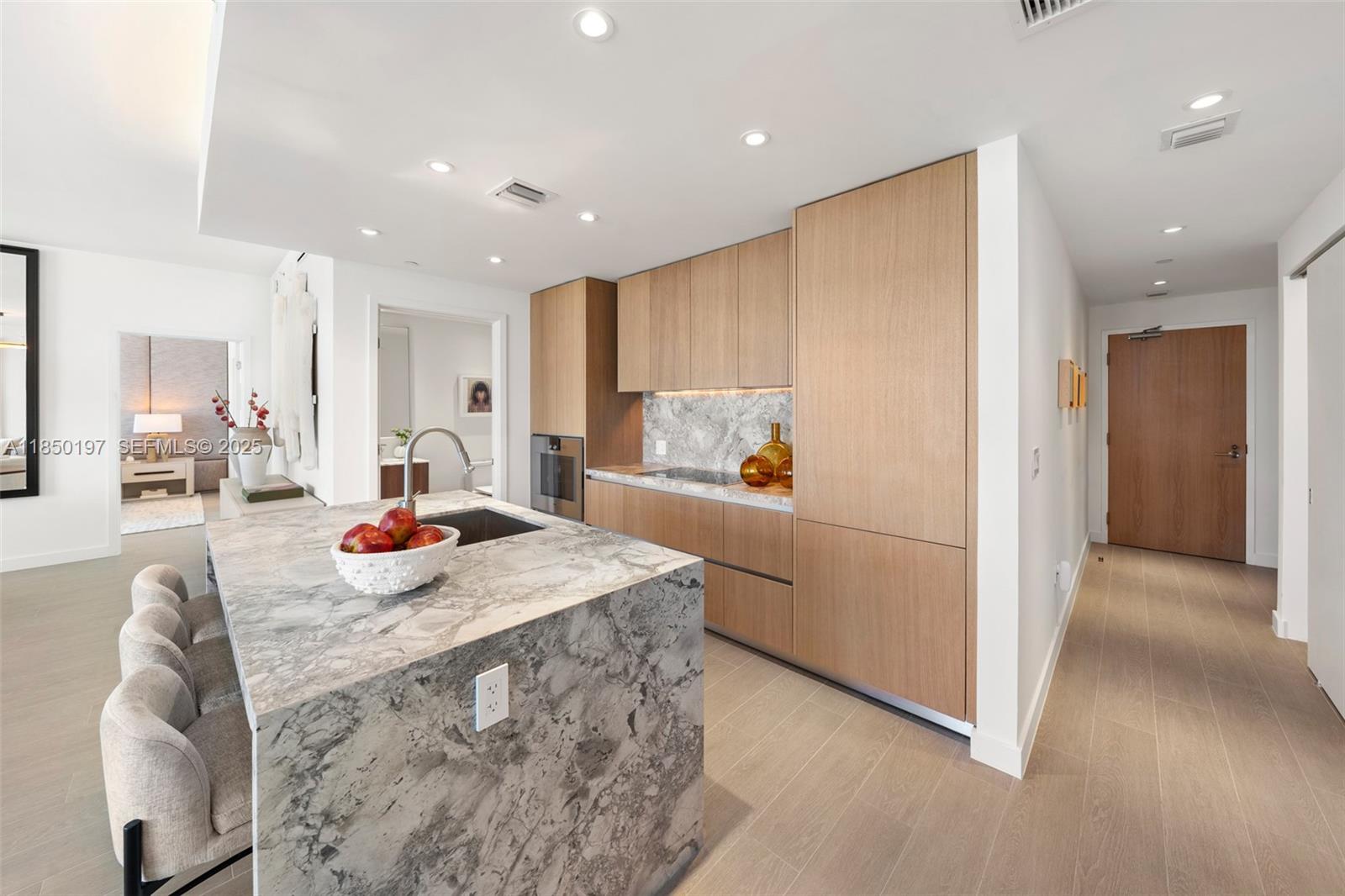 500 Alton Road, Unit 807 Miami Beach, FL 33139 - Photo 7 of 20 a kitchen with stainless steel appliances granite countertop a sink refrigerator and cabinets
