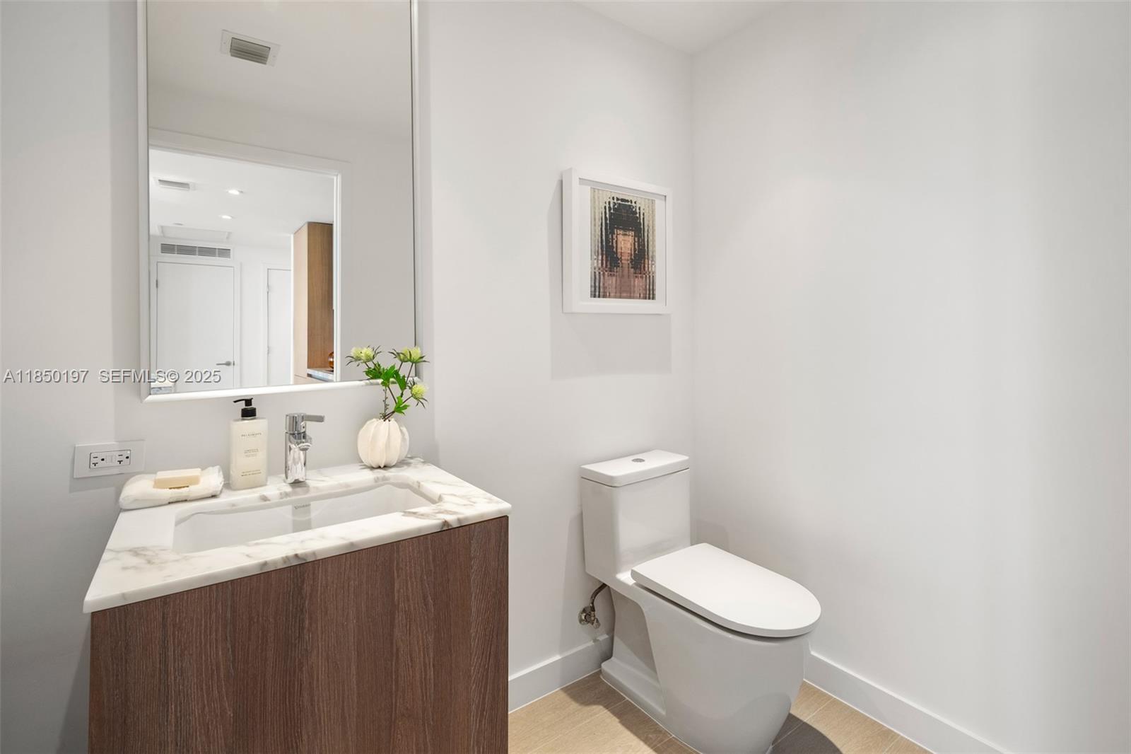 500 Alton Road, Unit 807 Miami Beach, FL 33139 - Photo 8 of 20 a bathroom with a sink and a toilet