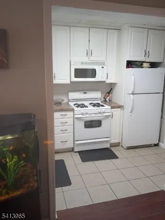a kitchen with a stove top oven and cabinets