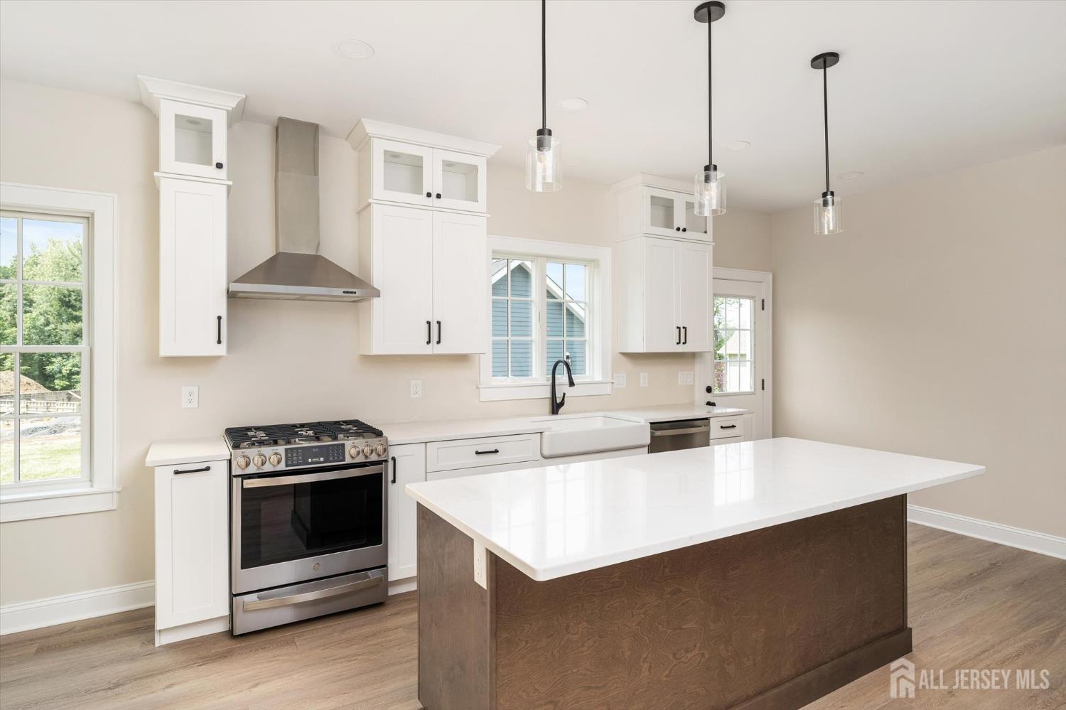 438 Ellisdale Road Chesterfield, NJ 08515 - Photo 11 of 28 a kitchen with stainless steel appliances a stove a sink a chimney and cabinets