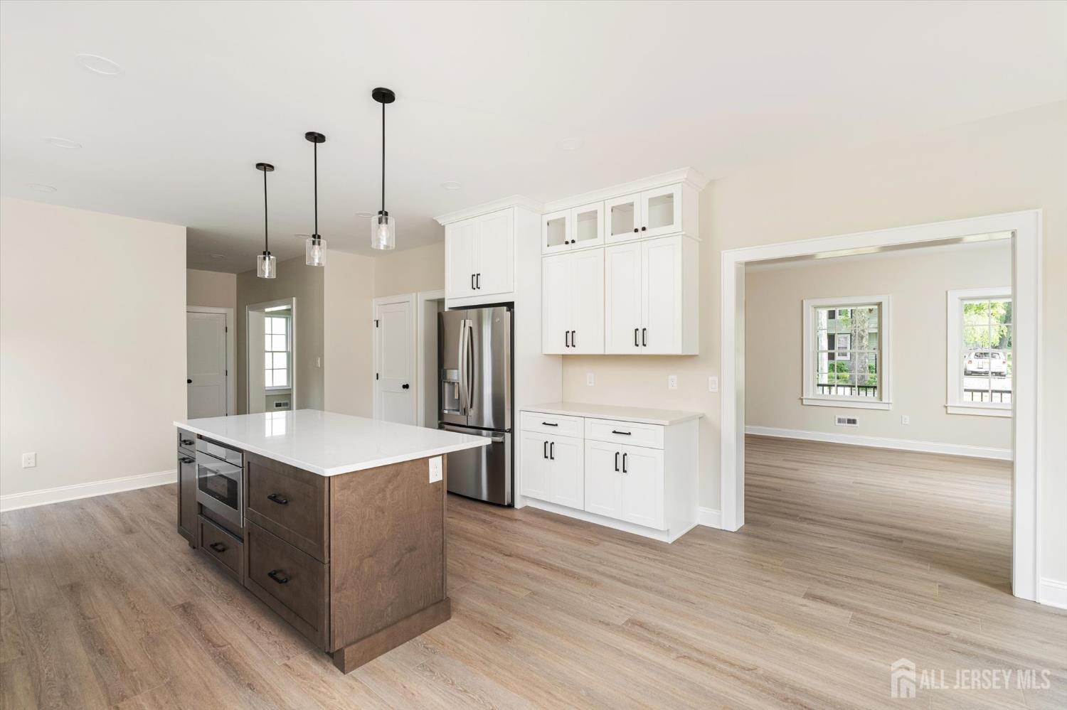 438 Ellisdale Road Chesterfield, NJ 08515 - Photo 13 of 28 a kitchen with a stove a refrigerator a sink and dishwasher with wooden floor