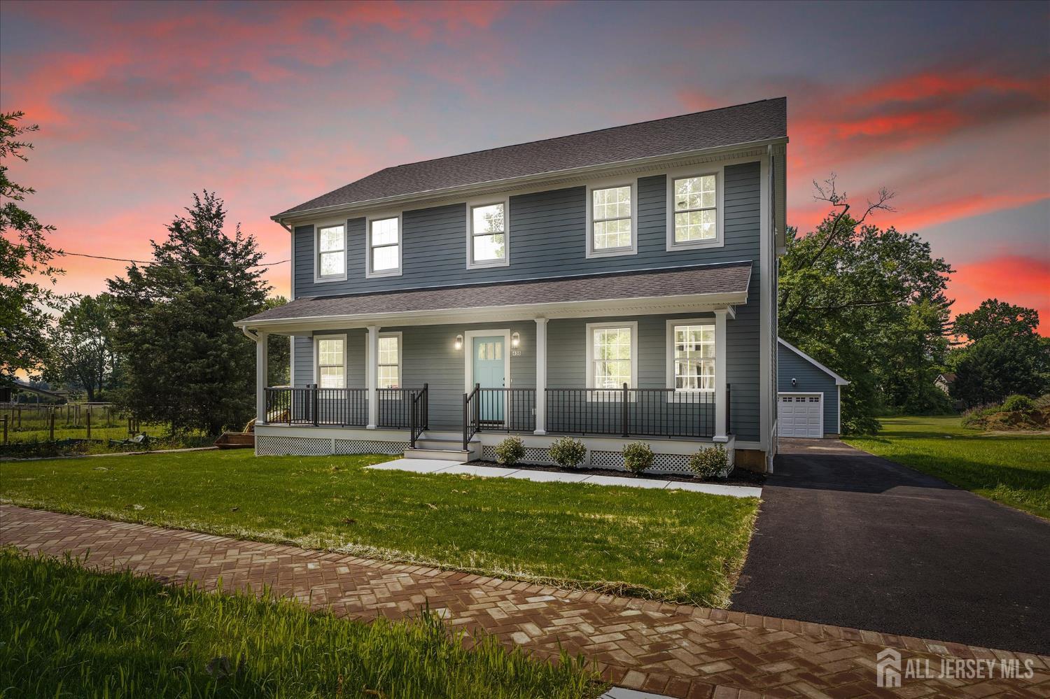 438 Ellisdale Road Chesterfield, NJ 08515 - Photo 2 of 28 a front view of a house with garden and trees