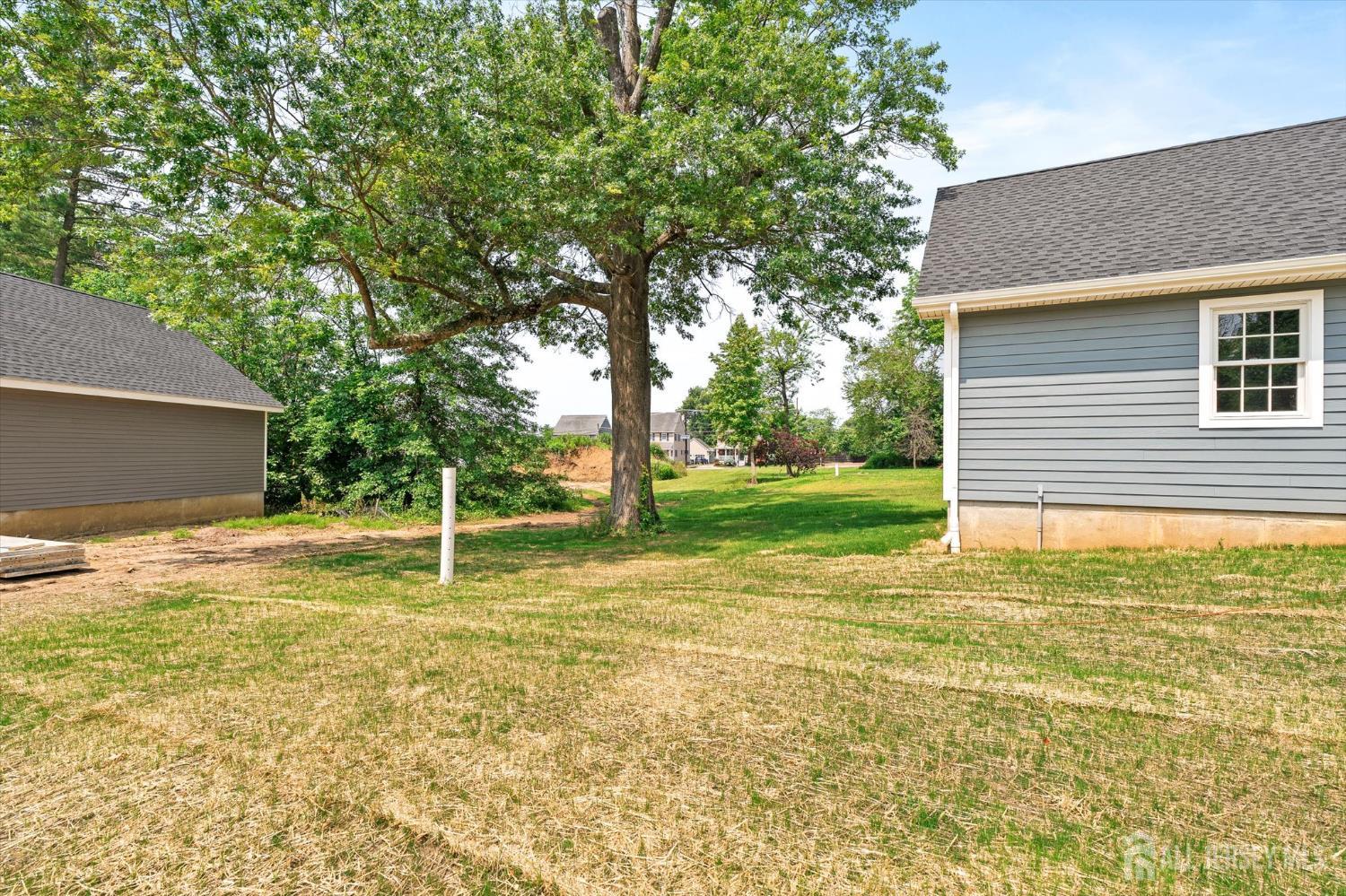 438 Ellisdale Road Chesterfield, NJ 08515 - Photo 28 of 28 a backyard of a house with table and chairs