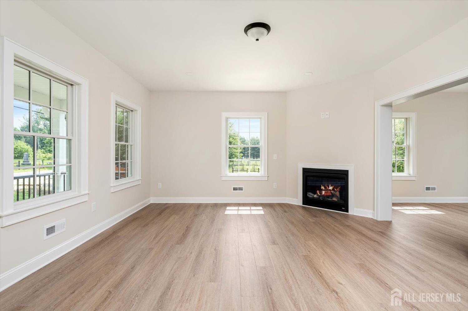 438 Ellisdale Road Chesterfield, NJ 08515 - Photo 5 of 28 an empty room with windows and fireplace