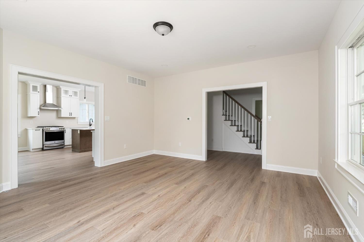 438 Ellisdale Road Chesterfield, NJ 08515 - Photo 6 of 28 an empty room with wooden floor and fireplace