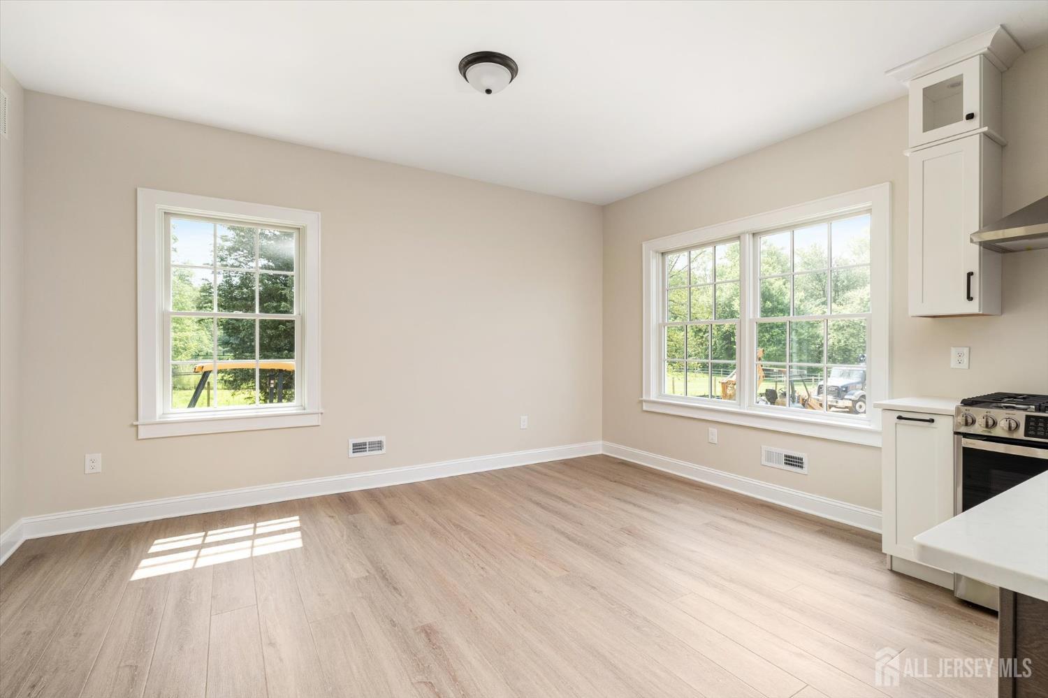438 Ellisdale Road Chesterfield, NJ 08515 - Photo 9 of 28 a view of an empty room with a window and wooden floor