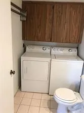 a bathroom with a toilet and a shower curtain