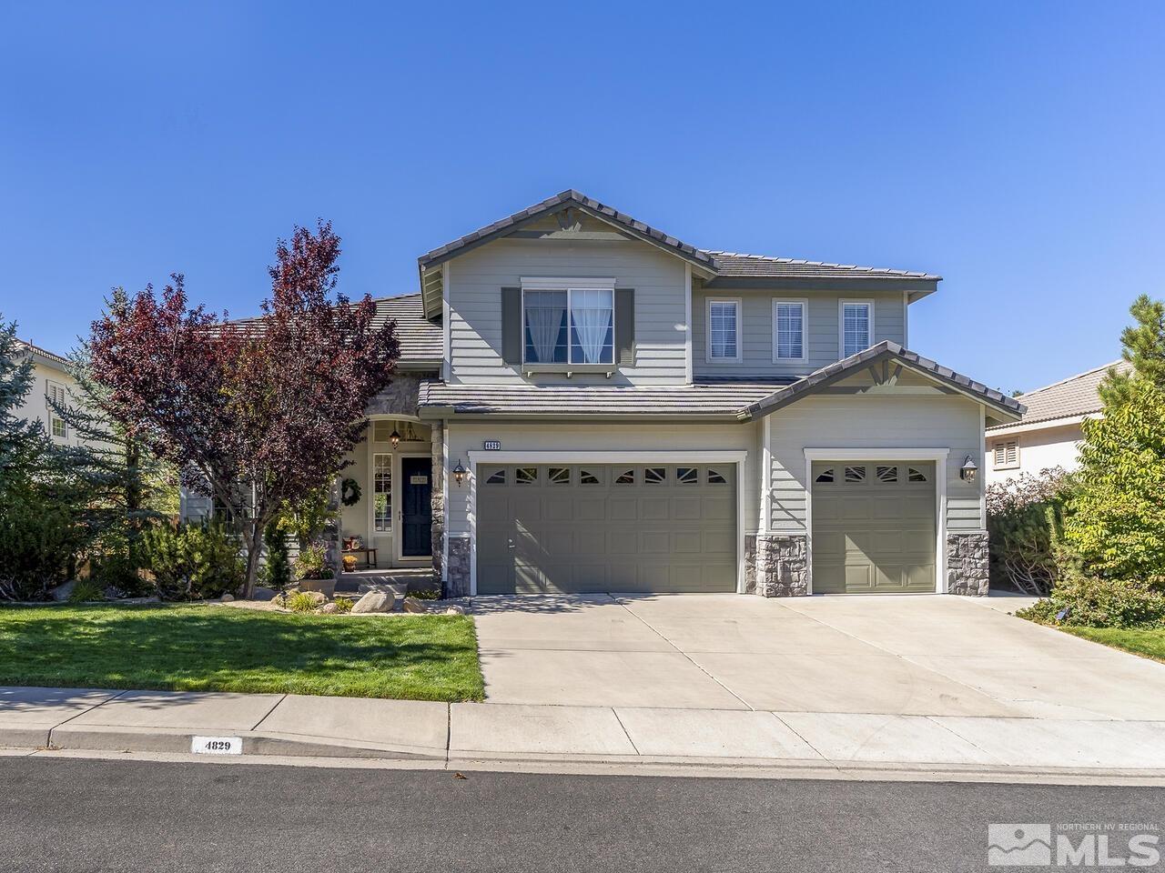 4829 Ramcreek Trail Reno, NV 89519 - Photo 1 of 40 a front view of a house with a garden and trees