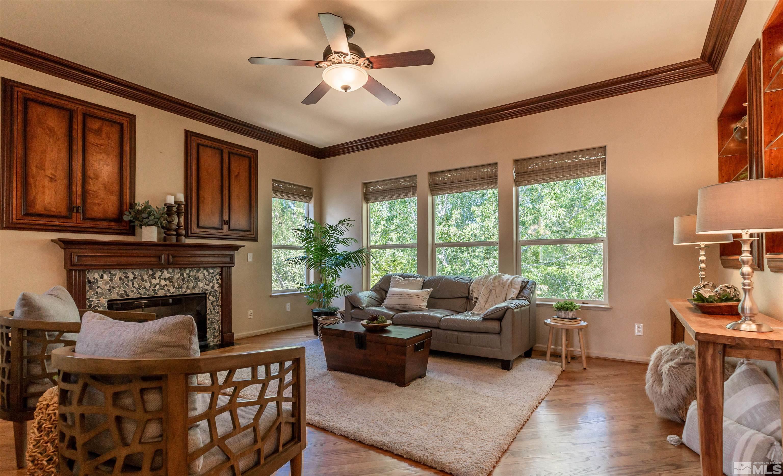 4829 Ramcreek Trail Reno, NV 89519 - Photo 11 of 40 a living room with furniture a fireplace and a large window