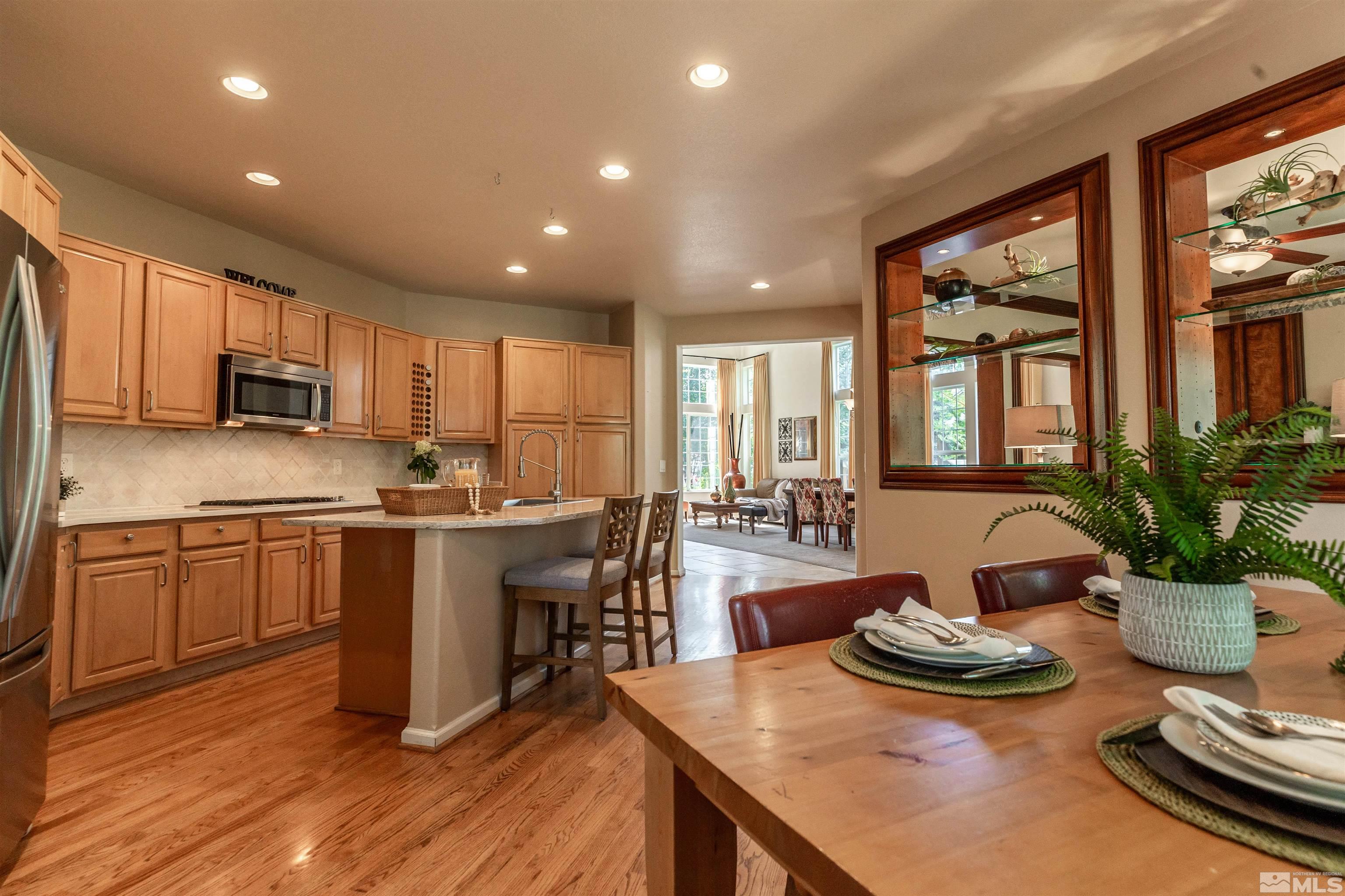 4829 Ramcreek Trail Reno, NV 89519 - Photo 12 of 40 a kitchen with sink refrigerator dining table and chairs