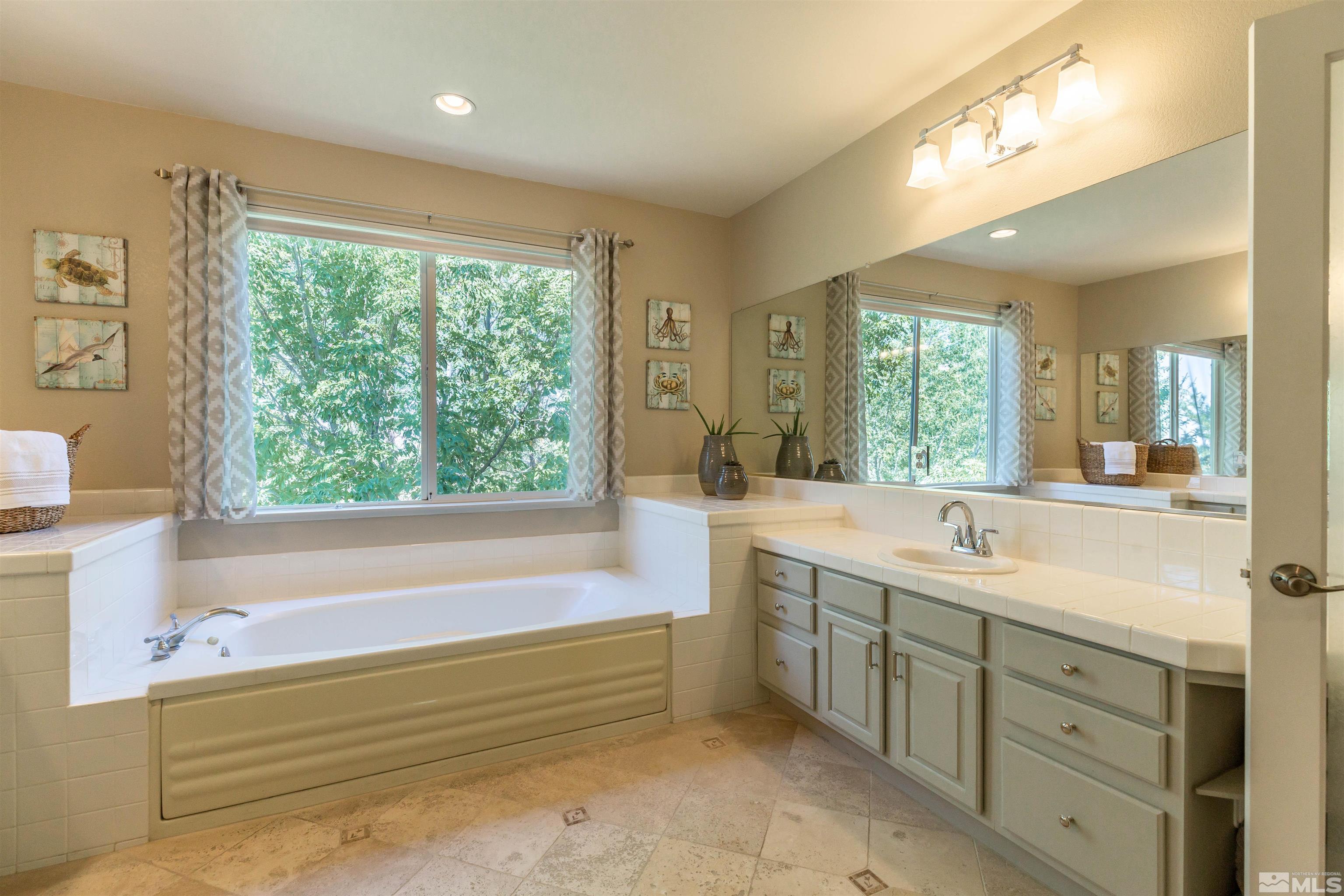 4829 Ramcreek Trail Reno, NV 89519 - Photo 19 of 40 a bathroom with a large tub sink and double vanity