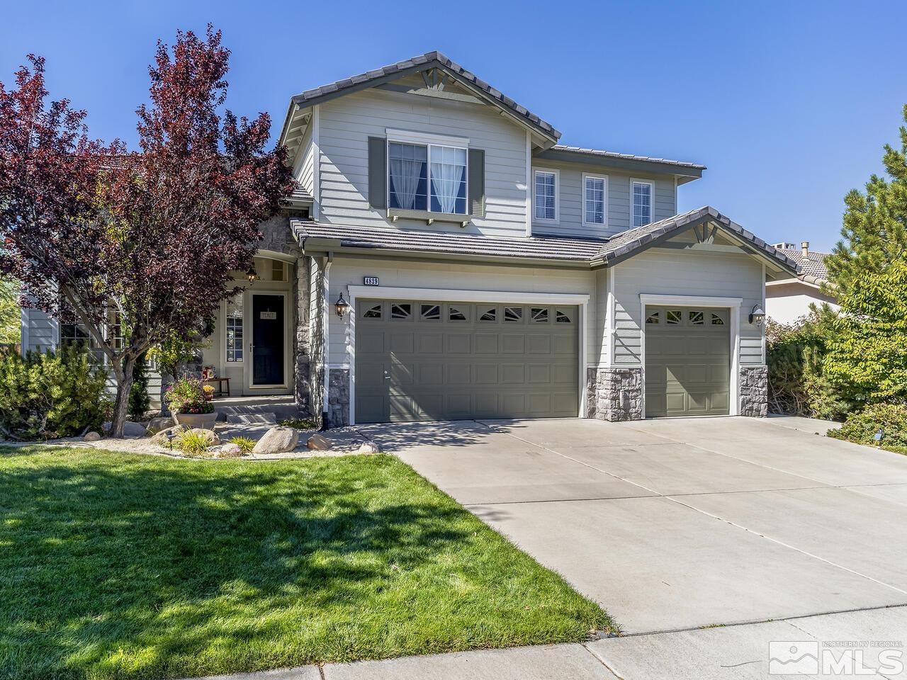 4829 Ramcreek Trail Reno, NV 89519 - Photo 2 of 40 a front view of a house with a garden and trees