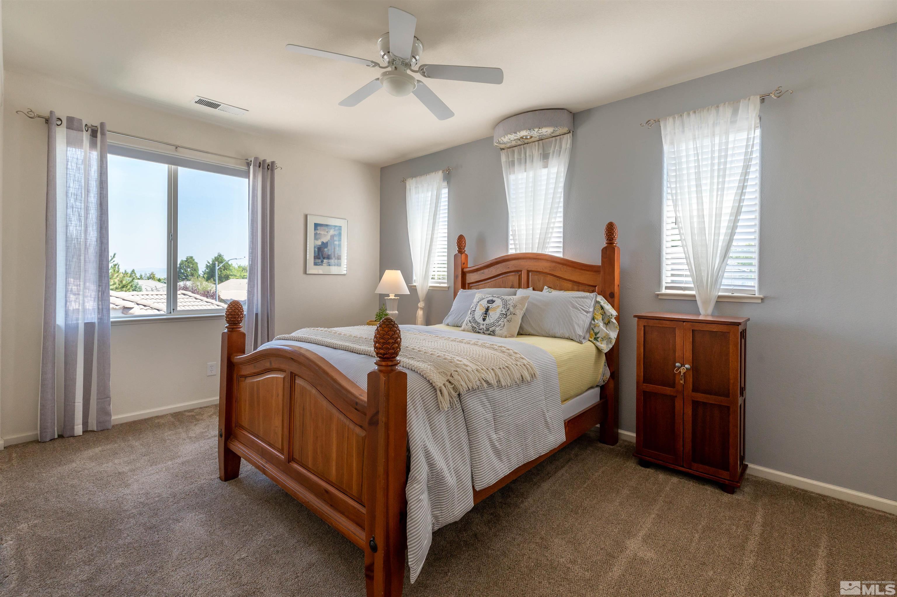 4829 Ramcreek Trail Reno, NV 89519 - Photo 24 of 40 a bedroom with a bed and a chandelier