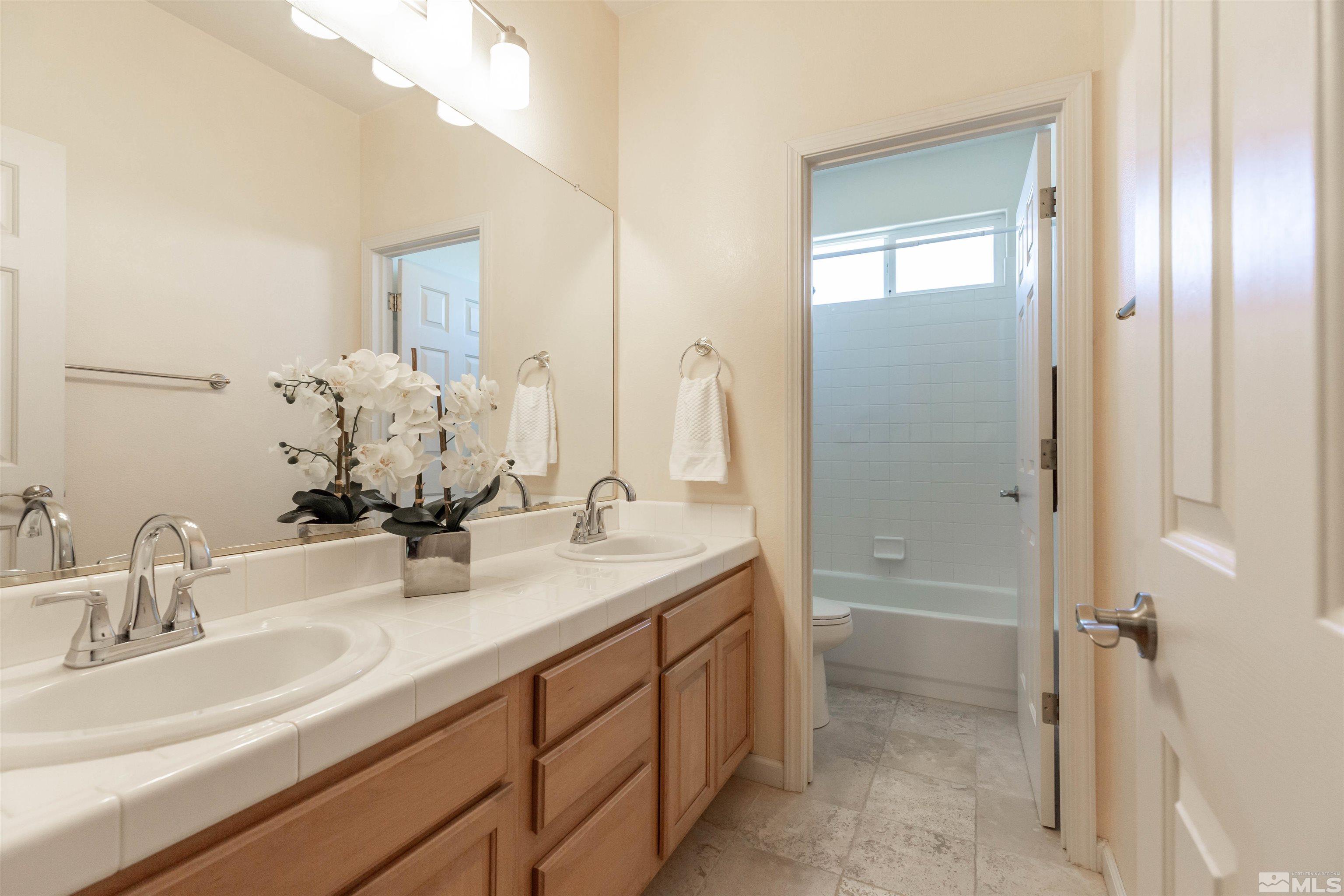 4829 Ramcreek Trail Reno, NV 89519 - Photo 26 of 40 a bathroom with a sink and a mirror