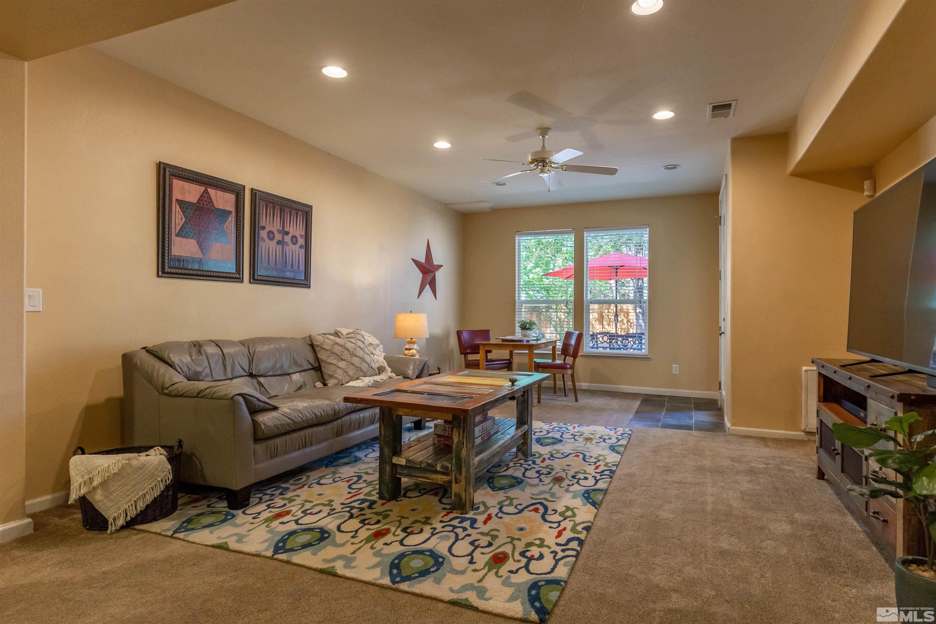 4829 Ramcreek Trail Reno, NV 89519 - Photo 27 of 40 a living room with furniture a window and a flat screen tv