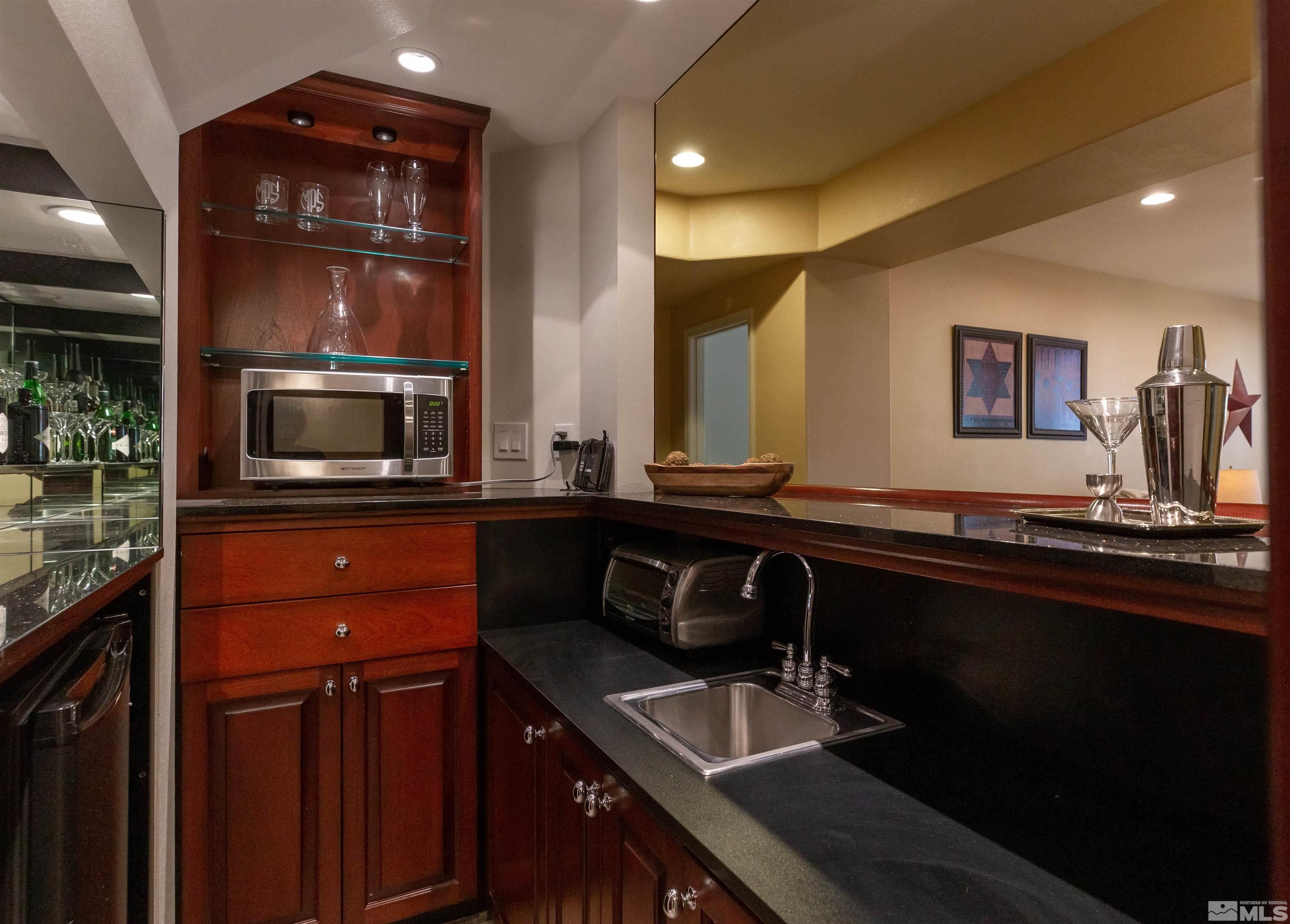 4829 Ramcreek Trail Reno, NV 89519 - Photo 29 of 40 a kitchen with stainless steel appliances a sink stove and microwave