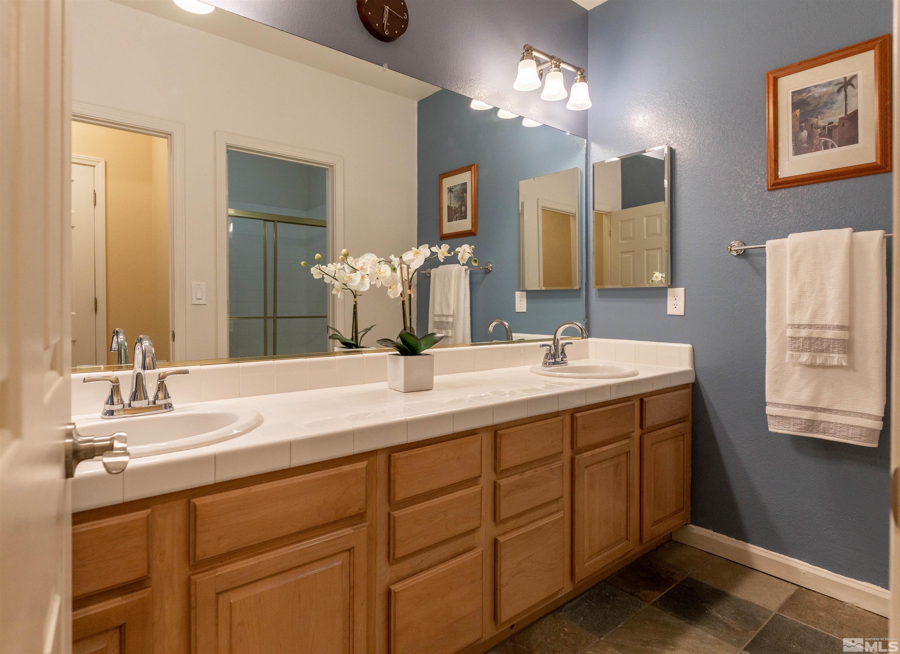 4829 Ramcreek Trail Reno, NV 89519 - Photo 36 of 40 a bathroom with a double vanity sink and a mirror