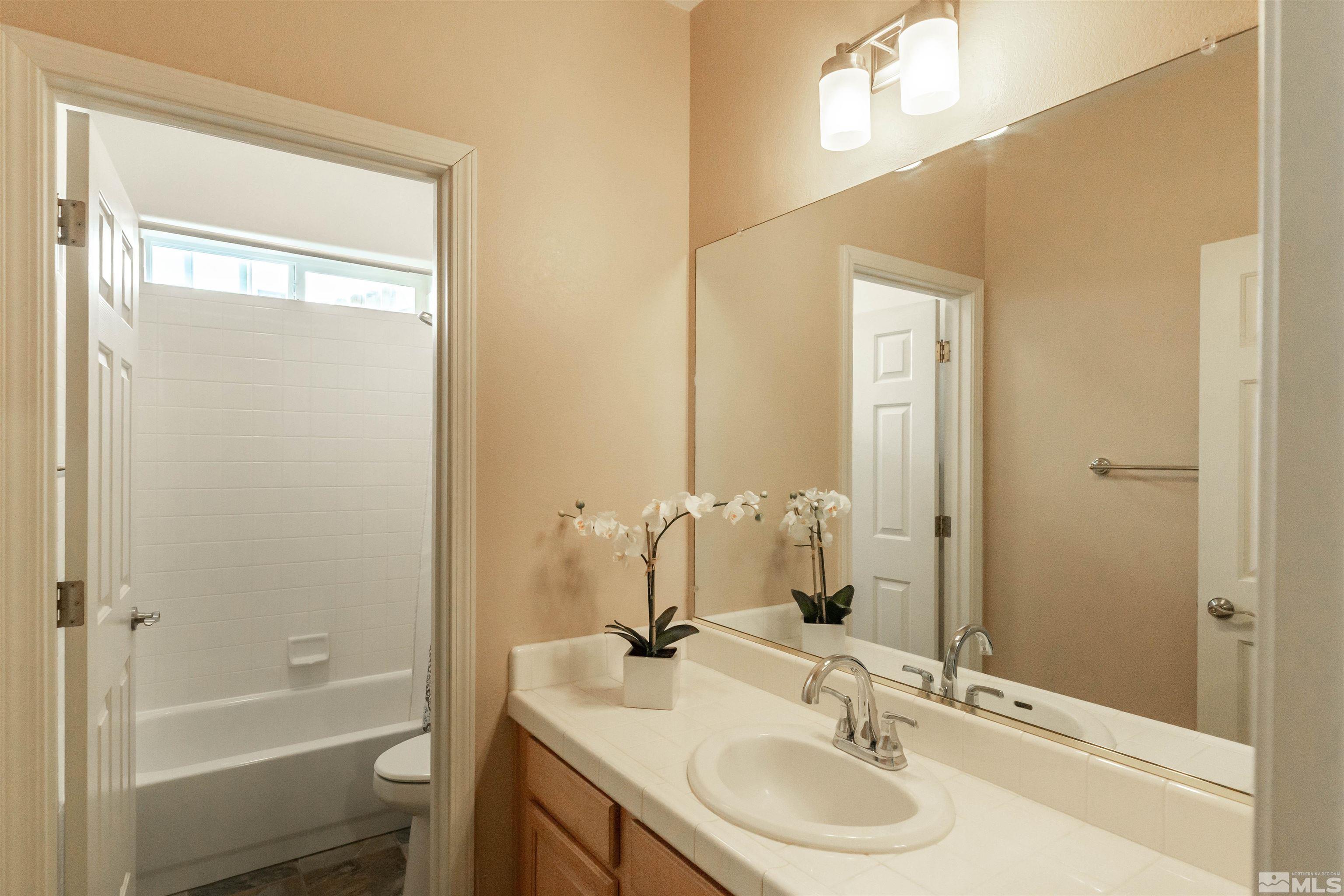 4829 Ramcreek Trail Reno, NV 89519 - Photo 38 of 40 a bathroom with a granite countertop sink toilet and shower