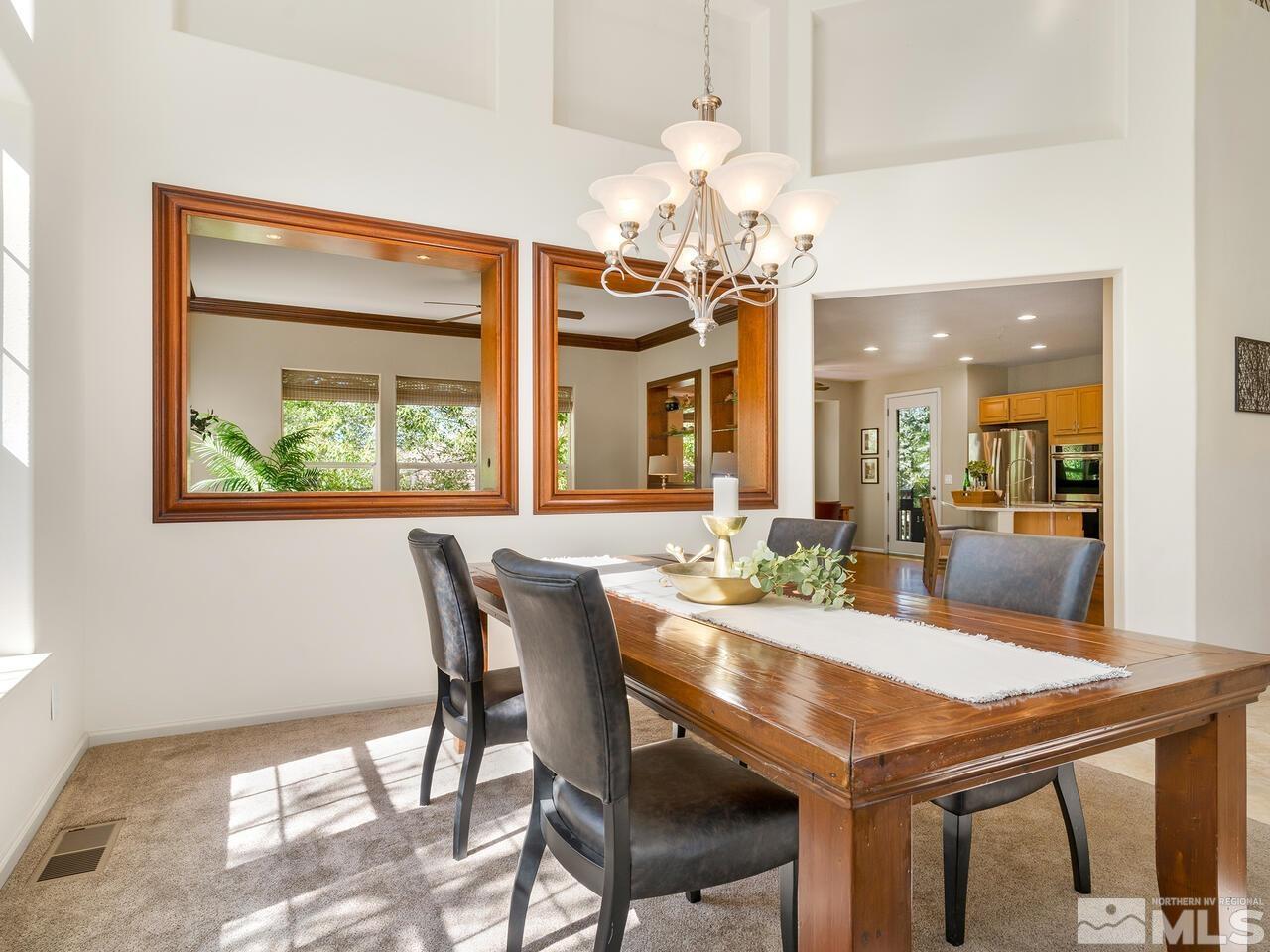 4829 Ramcreek Trail Reno, NV 89519 - Photo 9 of 40 a view of a dining room with furniture a chandelier and wooden floor