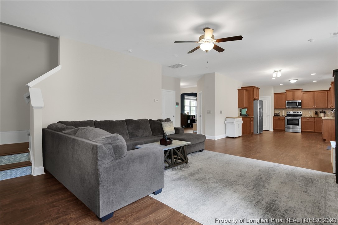 90 Eaker Drive Cameron, NC 28326 - Photo 14 of 36 a living room with furniture and a chandelier