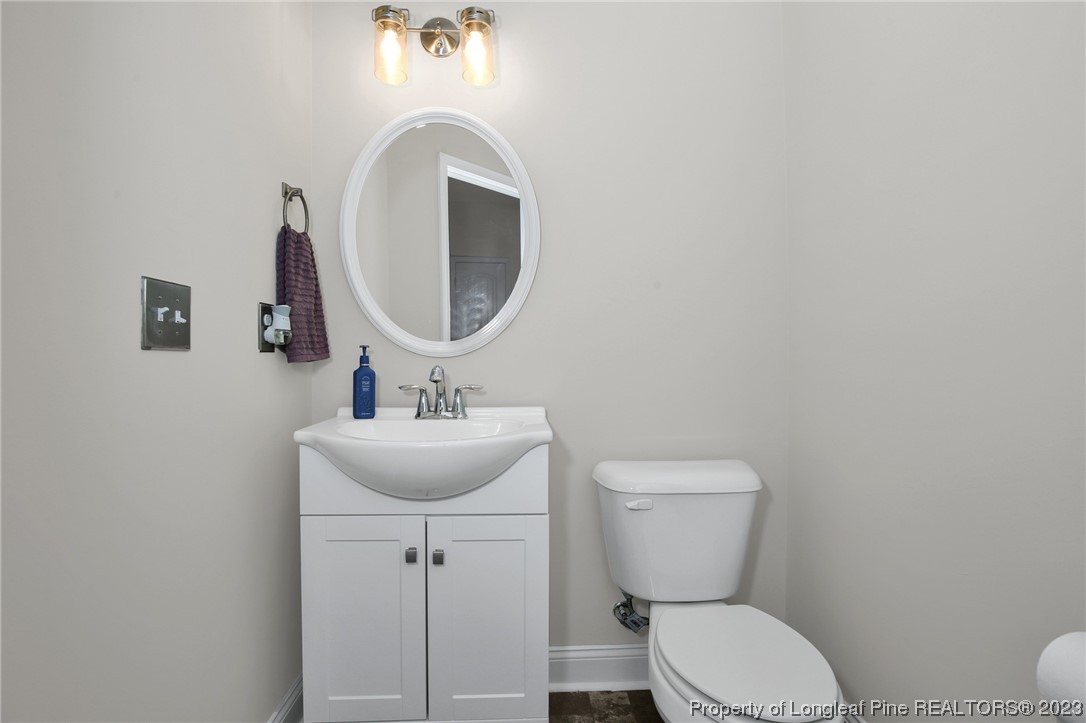 90 Eaker Drive Cameron, NC 28326 - Photo 17 of 36 a bathroom with a toilet sink and mirror