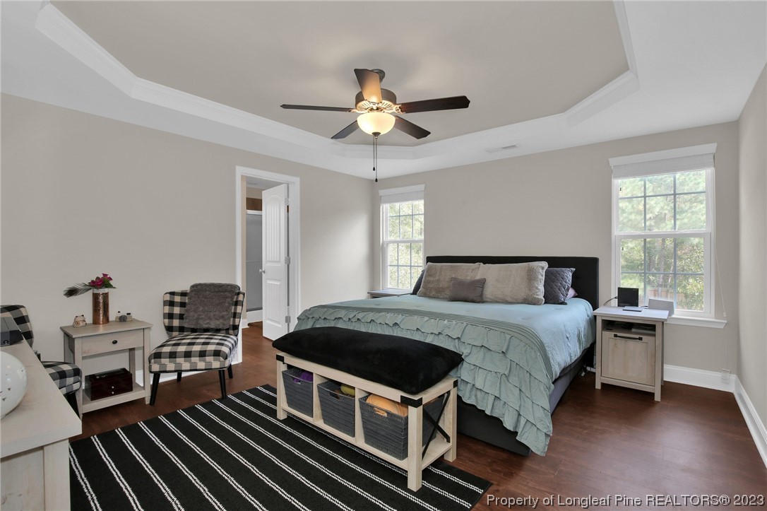 90 Eaker Drive Cameron, NC 28326 - Photo 19 of 36 a bedroom with a bed and a chandelier