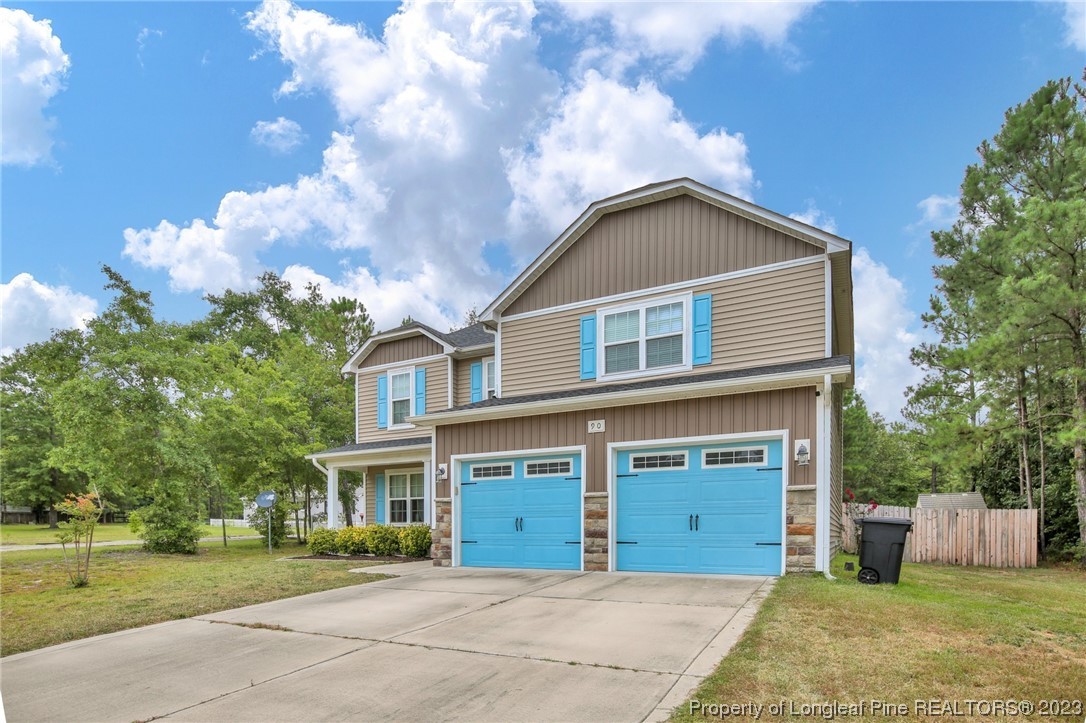 90 Eaker Drive Cameron, NC 28326 - Photo 2 of 36 a front view of a house with garden
