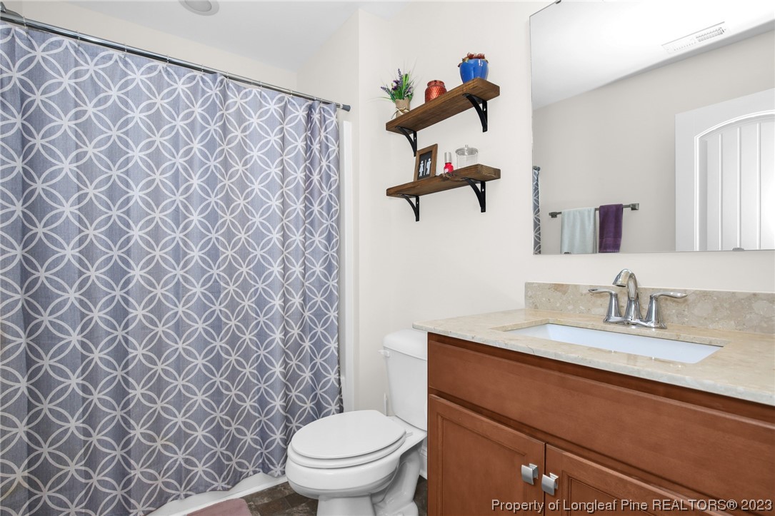 90 Eaker Drive Cameron, NC 28326 - Photo 22 of 36 a bathroom with a granite countertop sink and a toilet