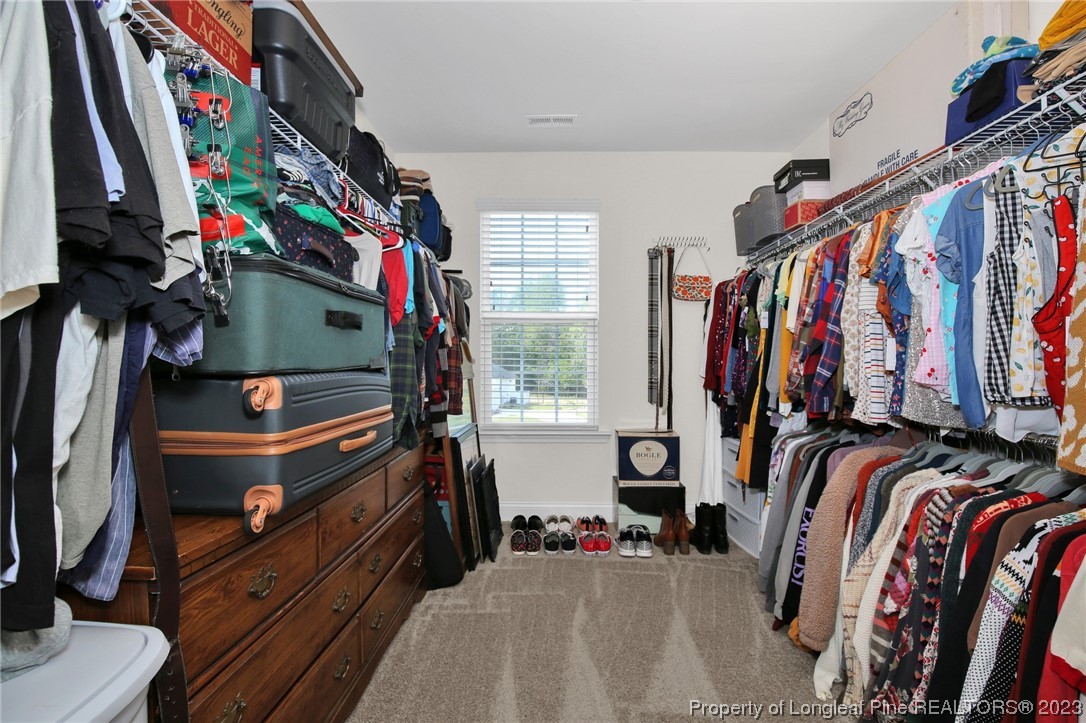 90 Eaker Drive Cameron, NC 28326 - Photo 25 of 36 a view of walk in closet with clothes and shoes