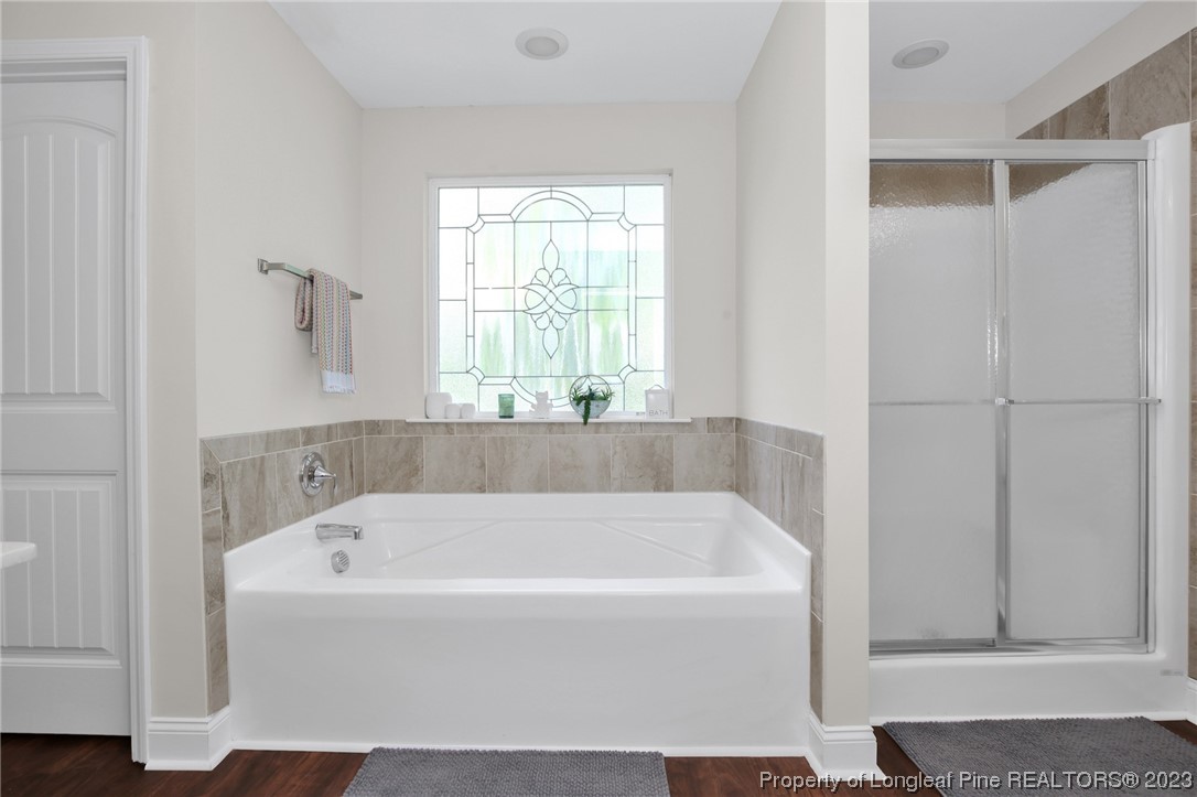 90 Eaker Drive Cameron, NC 28326 - Photo 26 of 36 a white bath tub sitting in a bathroom next to a window