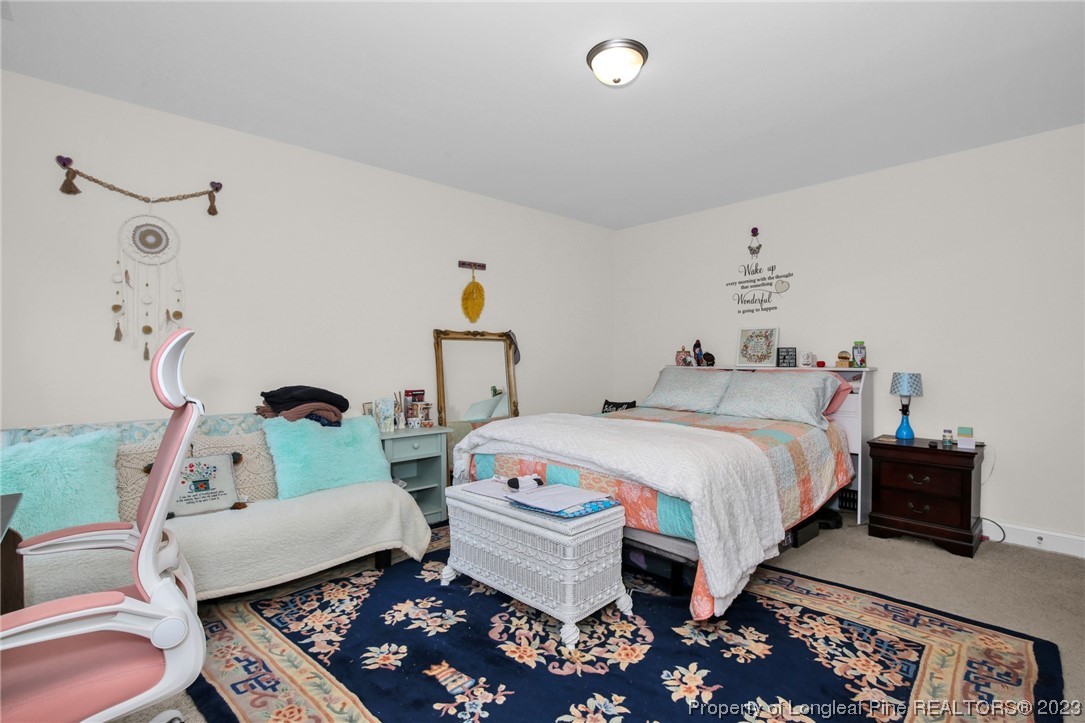 90 Eaker Drive Cameron, NC 28326 - Photo 29 of 36 a bedroom with a bed and wooden floor