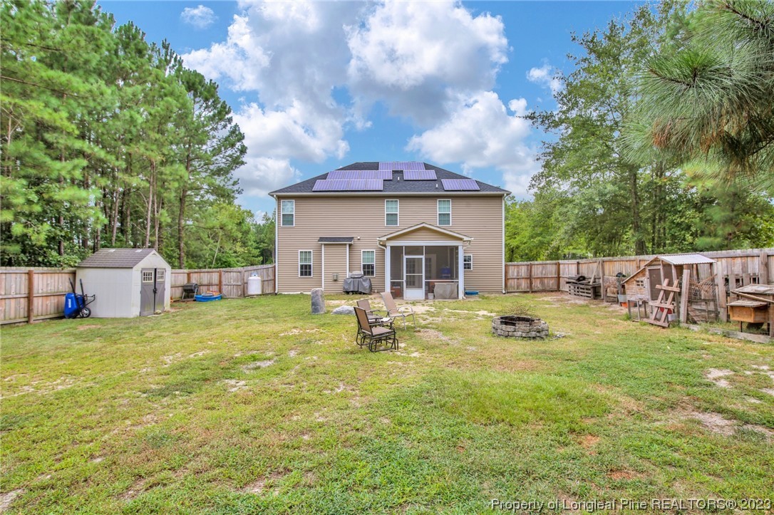 90 Eaker Drive Cameron, NC 28326 - Photo 30 of 36 a view of house with backyard and a slide