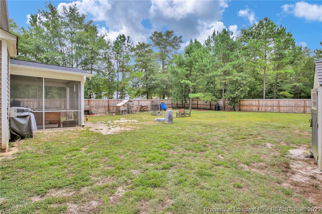 90 Eaker Drive Cameron, NC 28326 - Photo 34 of 36 a view of a house with a yard porch and sitting area