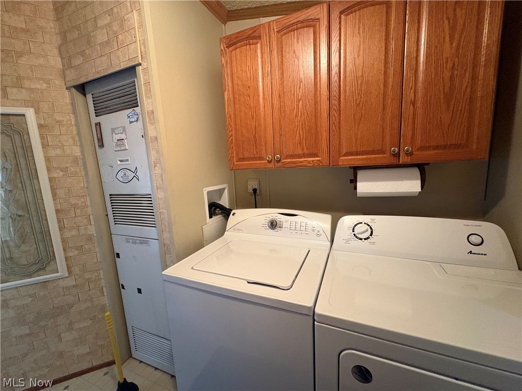 4455 Cleveland Road, Unit 20 Wooster, OH 44691 - Photo 20 of 38 Laundry room with cabinet space, a heating unit, and washer and dryer