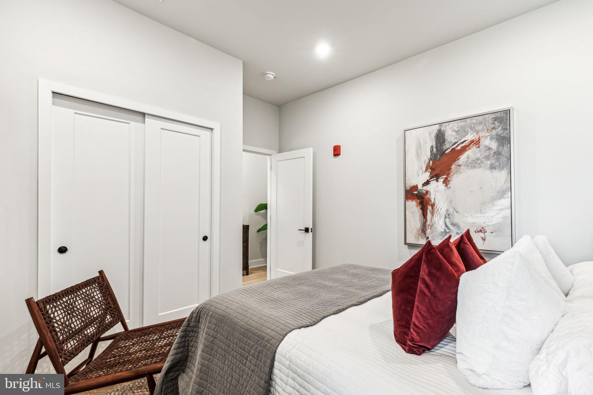 6910 Ridge Avenue, Unit 413 Philadelphia, PA 19128 - Photo 12 of 16 a bedroom with a bed and a painting on the wall