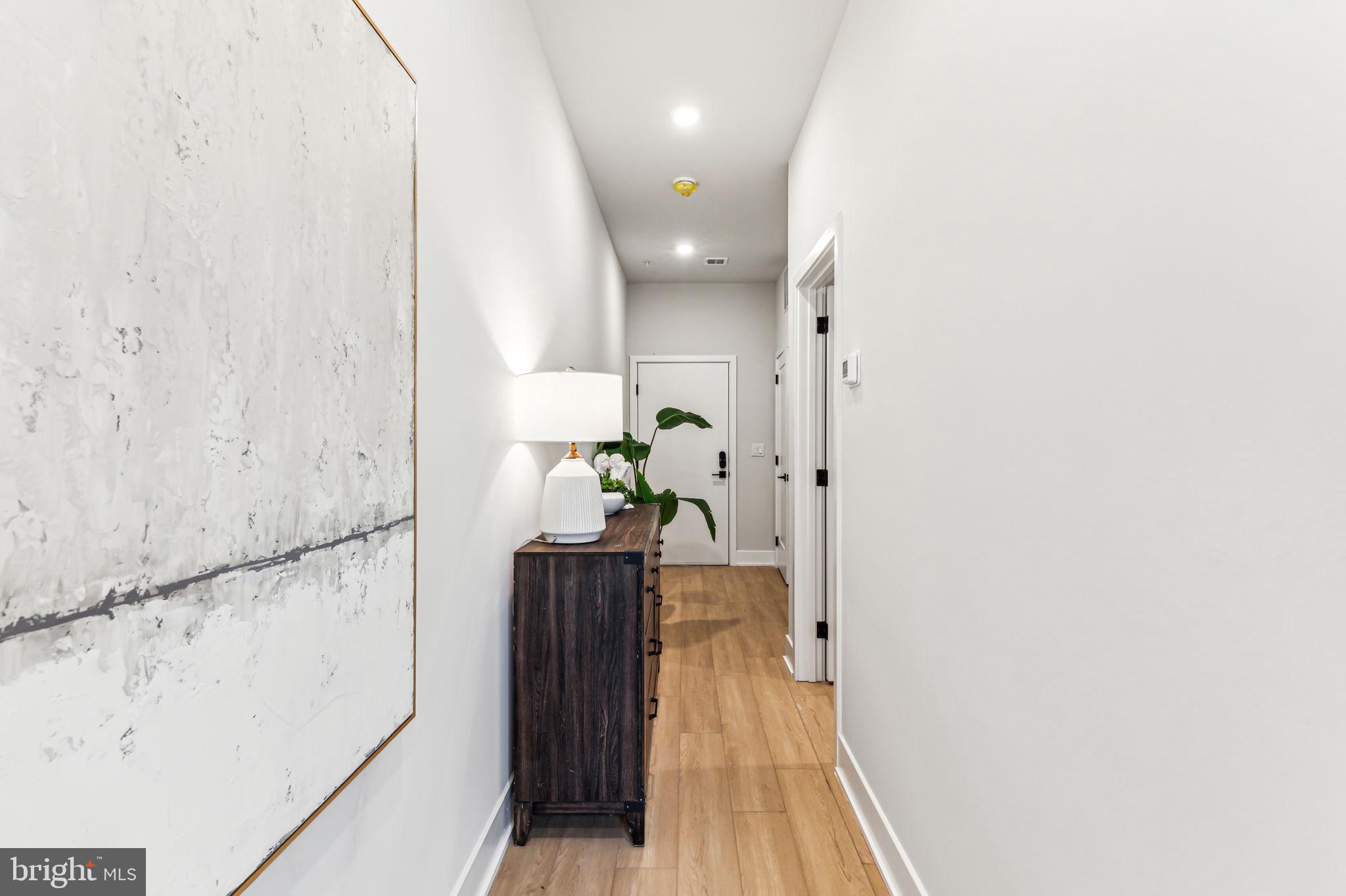 6910 Ridge Avenue, Unit 413 Philadelphia, PA 19128 - Photo 14 of 16 a view of hallway with wooden floor