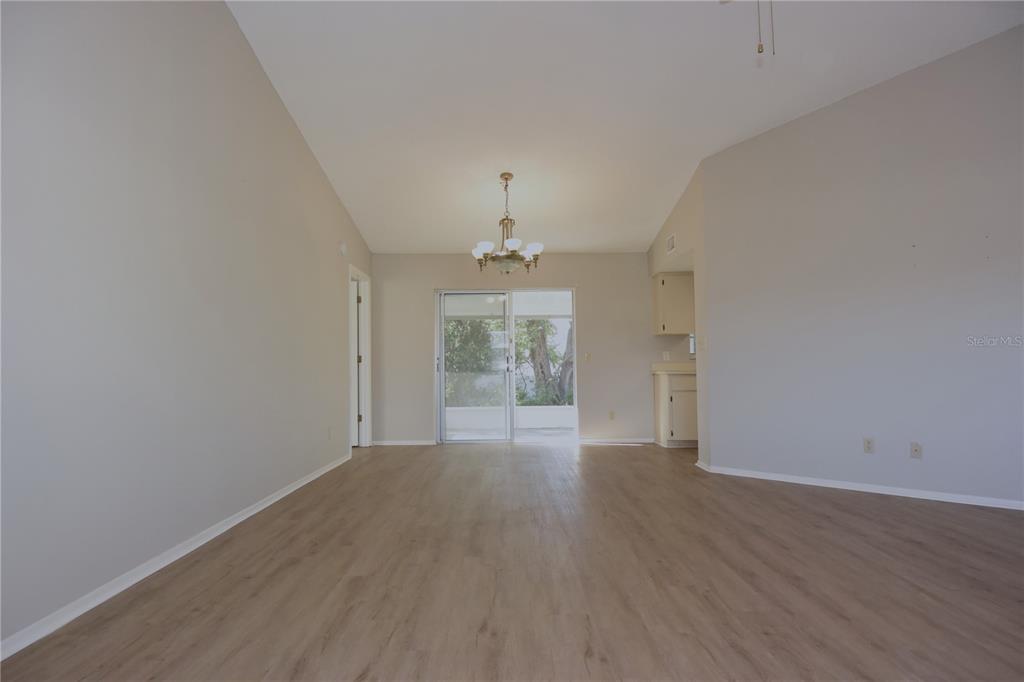 11341 Timbercrest Road Spring Hill, FL 34608 - Photo 11 of 35 wooden floor in an empty room with a window