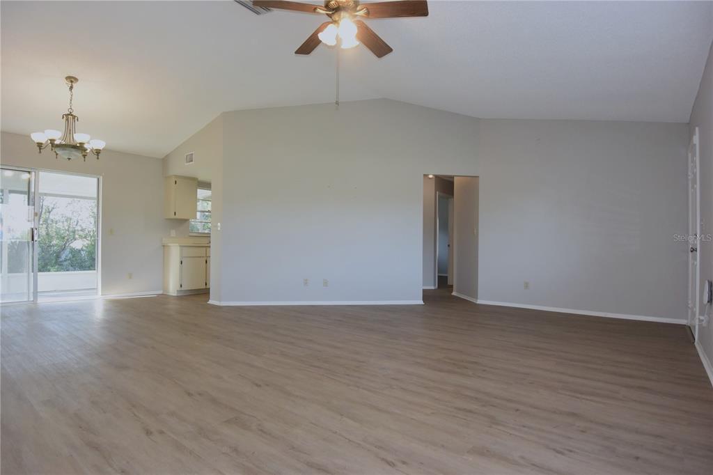 11341 Timbercrest Road Spring Hill, FL 34608 - Photo 12 of 35 a view of an empty room with a window and wooden floor