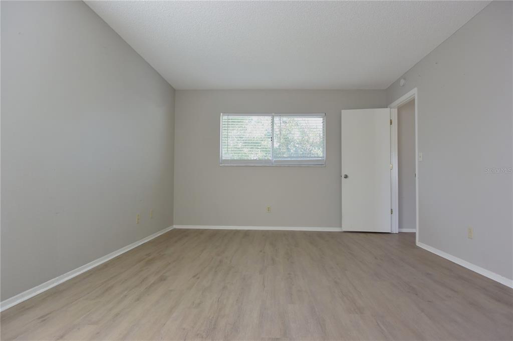 11341 Timbercrest Road Spring Hill, FL 34608 - Photo 14 of 35 an empty room with wooden floor and windows