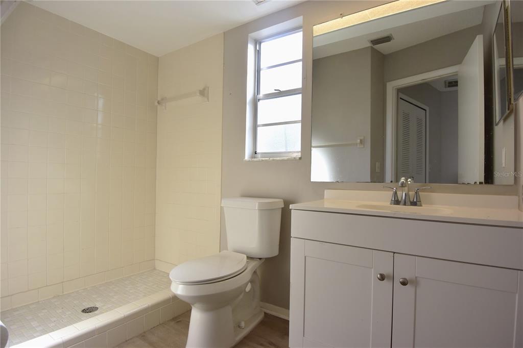 11341 Timbercrest Road Spring Hill, FL 34608 - Photo 15 of 35 a bathroom with a granite countertop sink toilet and shower