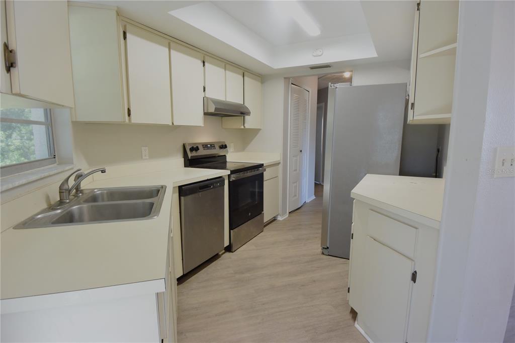 11341 Timbercrest Road Spring Hill, FL 34608 - Photo 17 of 35 a kitchen with a sink stove and refrigerator