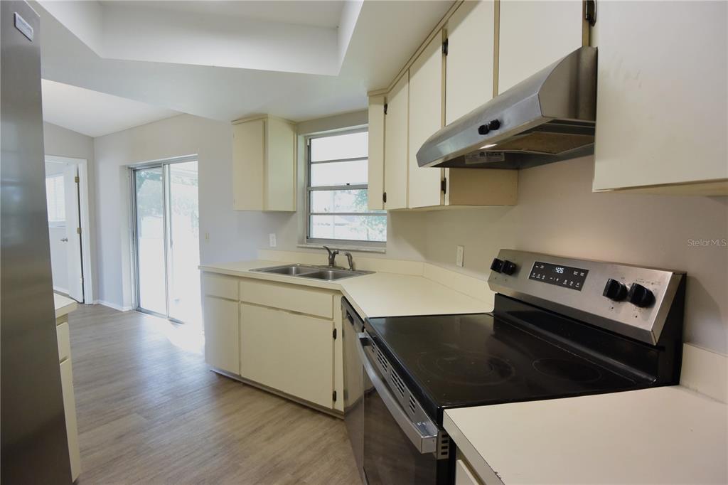 11341 Timbercrest Road Spring Hill, FL 34608 - Photo 18 of 35 a kitchen with stainless steel appliances a stove a sink and a refrigerator