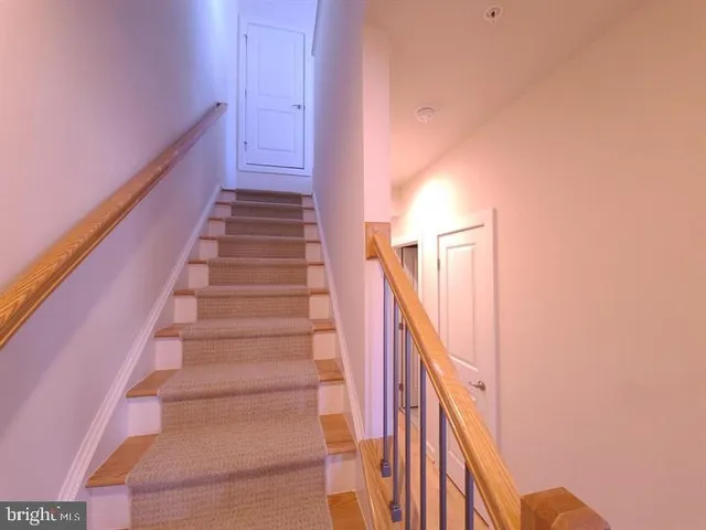 a bathroom with a sink vanity mirror and toilet