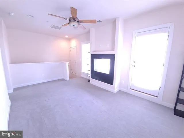 a bathroom with a granite countertop bathtub shower sink vanity and toilet