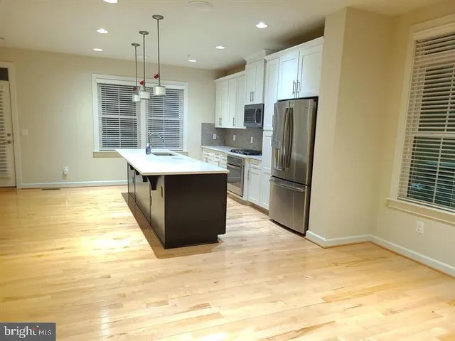 a view of a room with a furniture and a ceiling fan