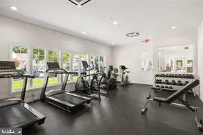 a room with gym equipment and large windows