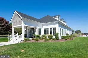 a front view of a house with a garden and plants