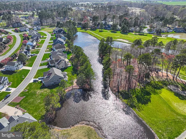 a view of a swimming pool with a yard and lake view