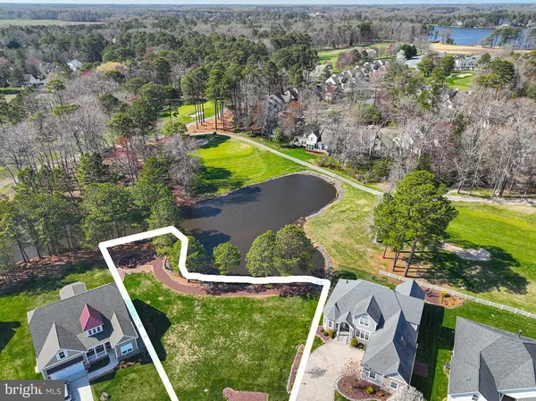 an aerial view of a house with a yard basket ball court and outdoor seating